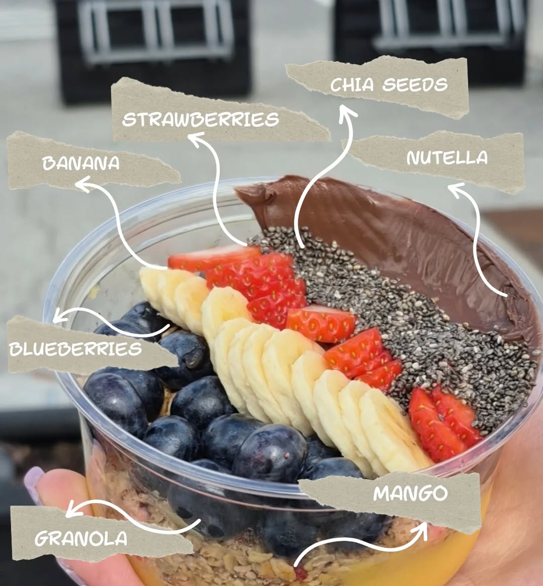 Acai bowl topped with banana, strawberries, mango, and Nutella